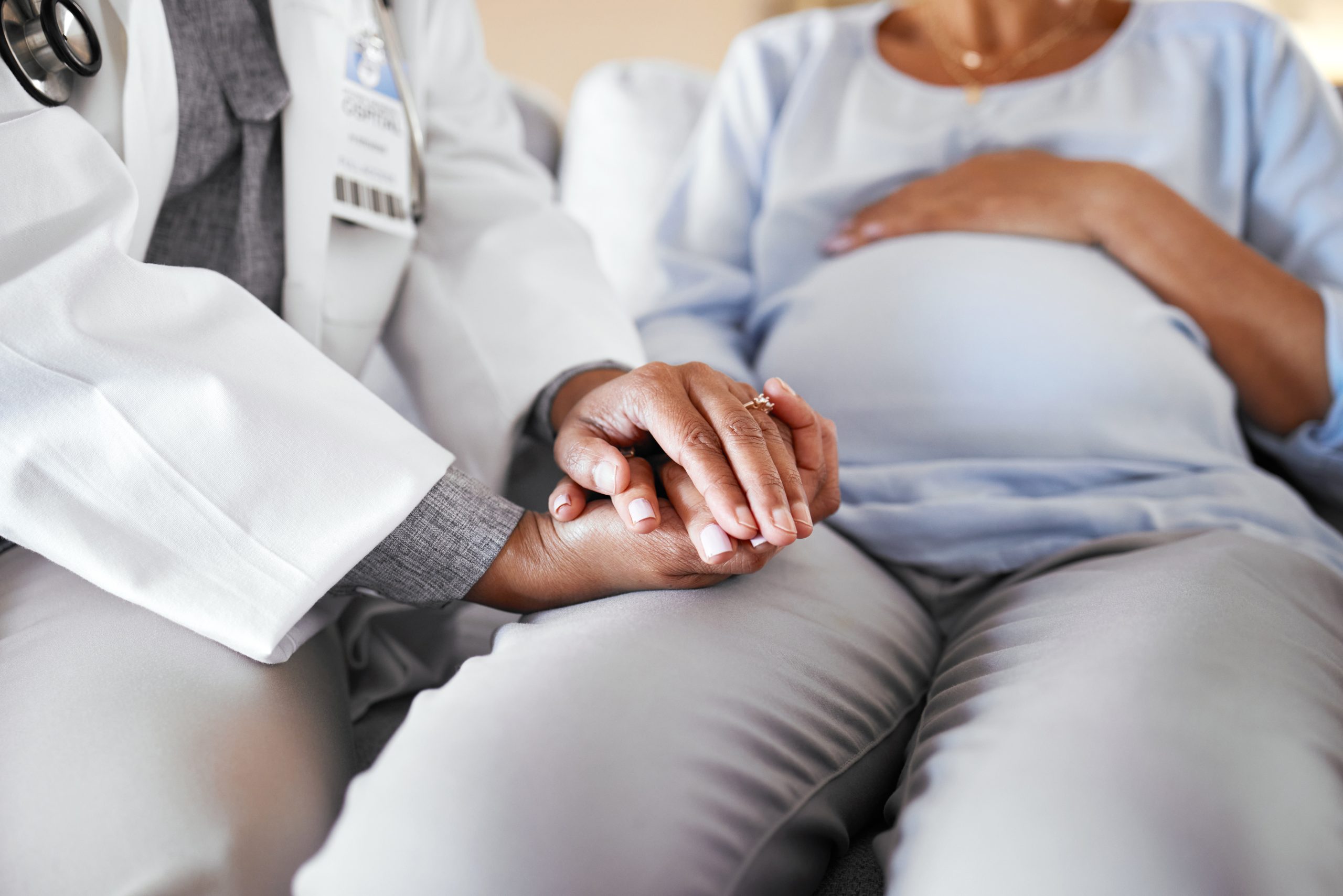 healthcare-doctor-sitting-and-holding-hands-with-2025-04-06-12-06-08-utc